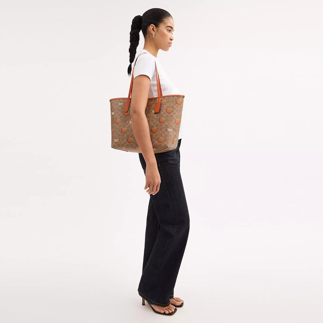 Coach Outlet City Tote Bag In Signature Canvas With Orange